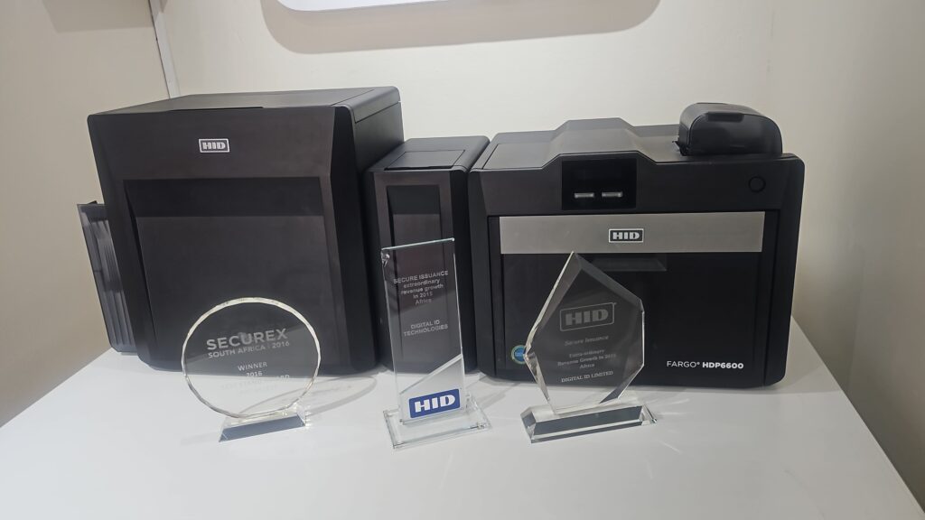 Digital ID Technologies awards from HID Global displayed in front of an HDP6600 ID card printer.